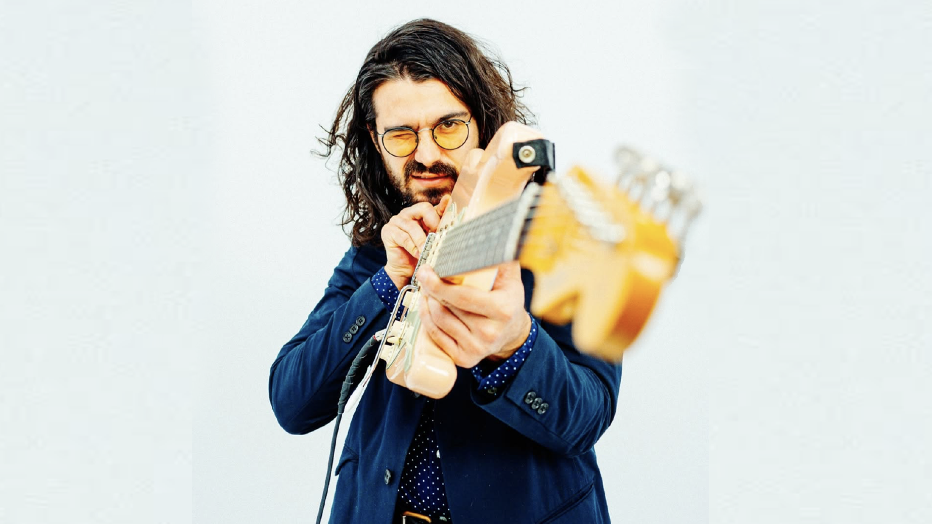 Paul Beladino holding electric guitar